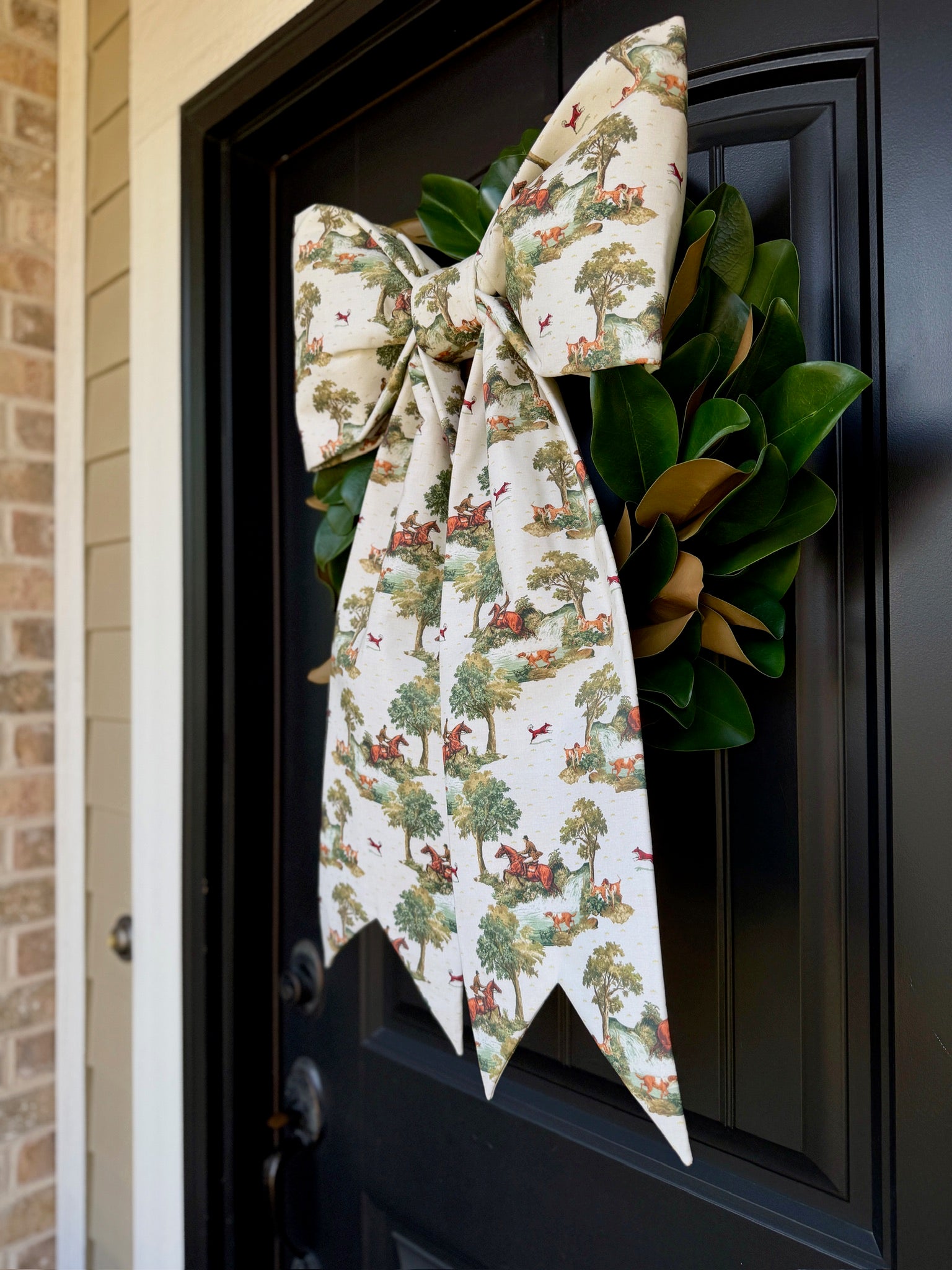Patriotic plaid bow and ribbon wreath on green leaves