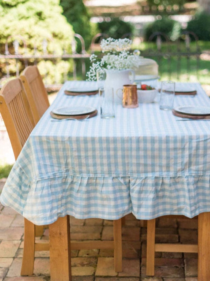Bluebell Gingham Ruffle Tablecloth styled on an outdoor summer dining table