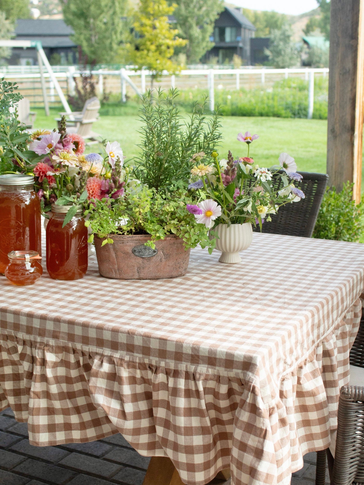 Biscuit Gingham Ruffle Tablecloth on a round dining table styled for brunch